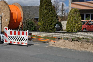Baustelle mit Schaufelbagger, eine Baggerschaufel schaufelt Sand aus einen Graben für ein...