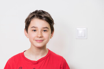 Teenage boy in red shirt. Portrait in studio. Funny faces.
