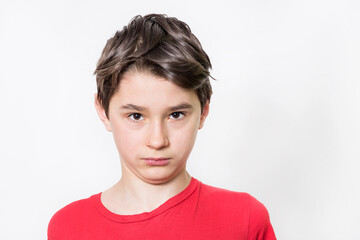 Teenage boy in red shirt. Portrait in studio. Funny faces.