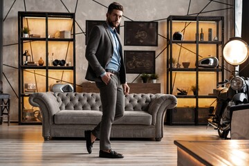 Full length of handsome young man looking away and keeping hands in pockets while walking through...