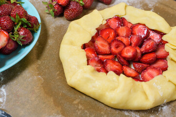 homemade strawberry Galette with fresh ripe strawberries on a dark background