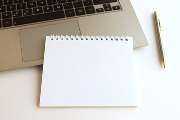 Modern workspace with notebook, tablet and laptop copy space on white color background. Top view. Flat lay style.