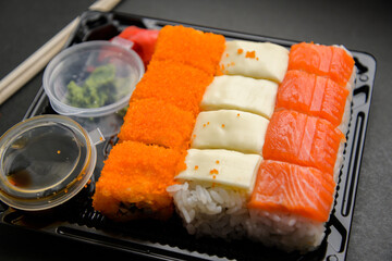 Set of various rolls in black plastic box.