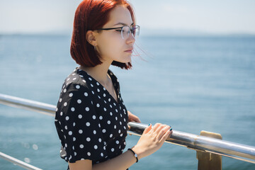 Woman in dress enjoys a walking near the sea shore.