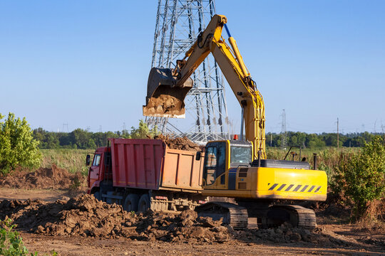 Dump truck and excavator on the construction site