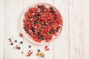 Colorful fresh berries on white background. Top view. Summer Organic Berry Cherry, Currant, Gooseberry. Agriculture, Gardening, Harvest Concept. Vitamins, Diet. Copy space. Healthly food, detox