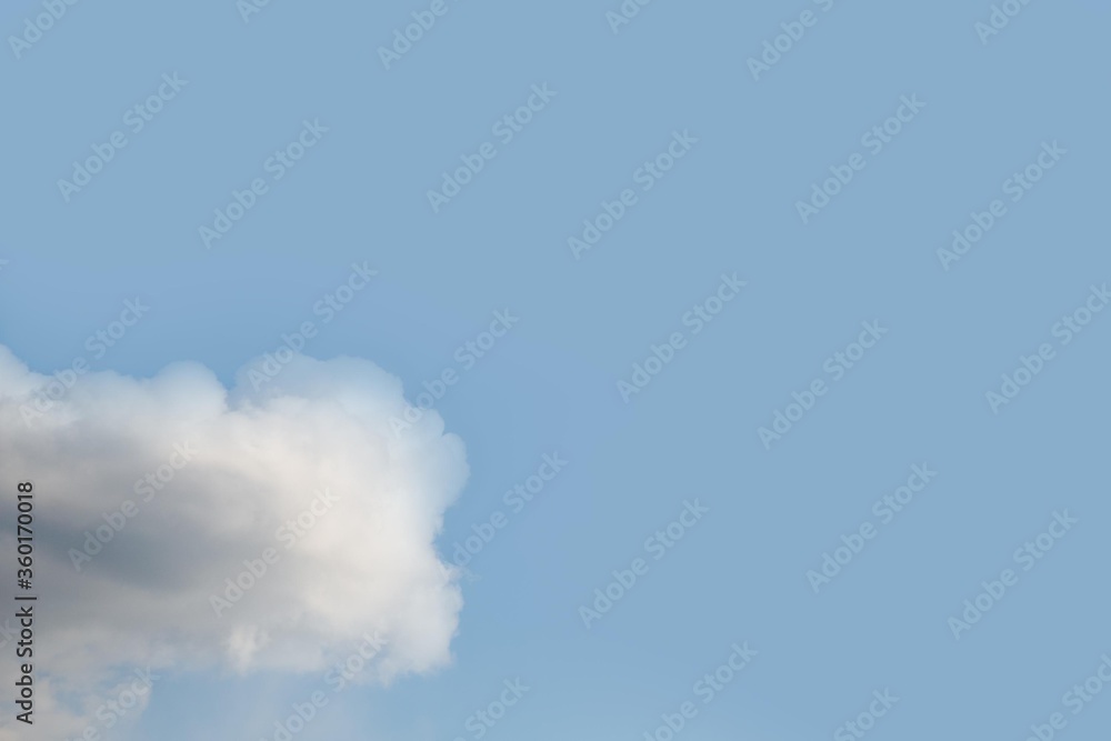 Wall mural One white cloud on clear blue sky background