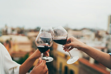 Group of people toasting outside, Best friends celebrating at rooftop party, Young friends hanging out with drinks, Close up shot of people making cheers, summer rooftop party concept