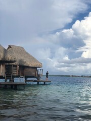 Man on deck of overwater bungalow in Bora Bora