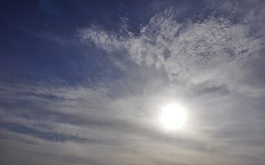 Panorama of the sunny sky. The sun in the haze of cirrostratus clouds. Signs of weather changes in the Western Urals.