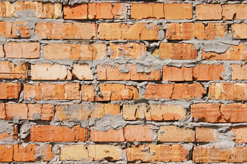 Old brick wall, old texture of red stone blocks closeup.