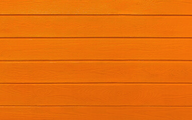 wooden boards painted in orange. Orange wood background.