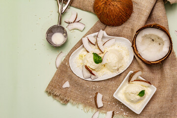 Lactose free coconut ice cream. Special spoon, halves of fruit, flakes