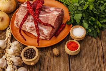 Raw pork meat. Fresh loin, spices, fragrant vegetables and parsley