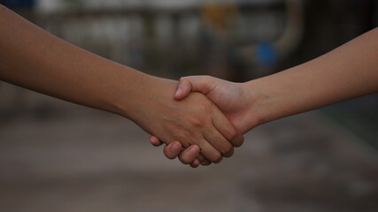 close up of two hands shaking hands
