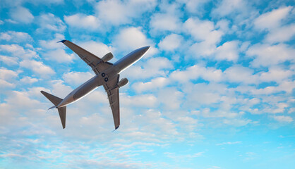 White passenger airplane in the clouds  - Travel by air transport