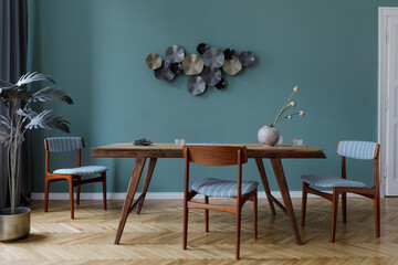 Modern and stylish dining room interior with glamour wooden table , elegant chairs, wooden parquet...