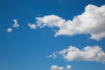 Naklejka na ściany i meble White clouds on the blue sky