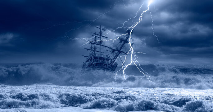 Sailing old ship in storm sea on the background heavy clouds with lightning