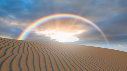 Rainbow over the sand dunes in the desert with sunset