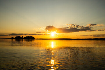 Naklejka premium Magical fairytale sunset in the evening on the lake