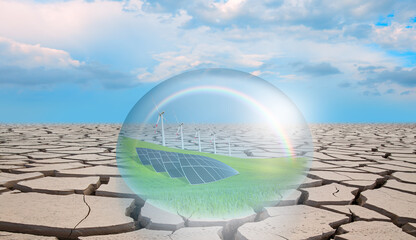 Global warming concept - Wind turbines and solar panels in the crystal sphere with dry soil