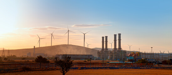 Industrial concept - Silhouette of Natural gas processing plant with Renewable energy wind turbines generating electricity