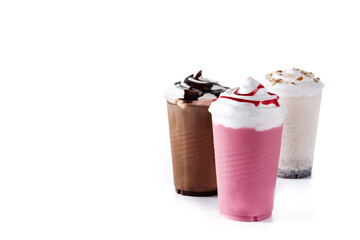 Strawberry, chocolate and white iced milkshakes isolated on white background. Copy space