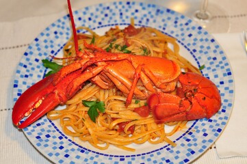 Lobster crayfish pasta eat lunch in restaurant. Seafood dish lobster spaghetti pasta on dinner. Cooked steamed red crustacean crayfish & italian pasta. Boiled lobster noodles. Crayfish crab food plate