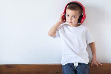 Young boy listening to music on headphones