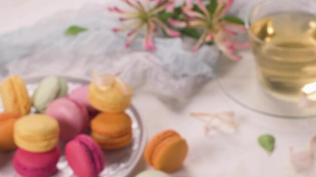 A french sweet delicacy, macaroons variety closeup. Color fresh macaroons on wooden background.