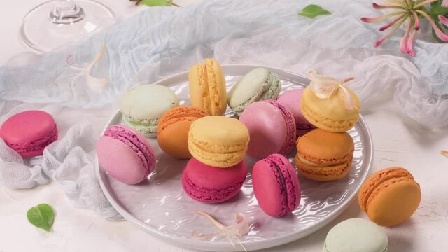 A french sweet delicacy, macaroons variety closeup. Color fresh macaroons on wooden background.