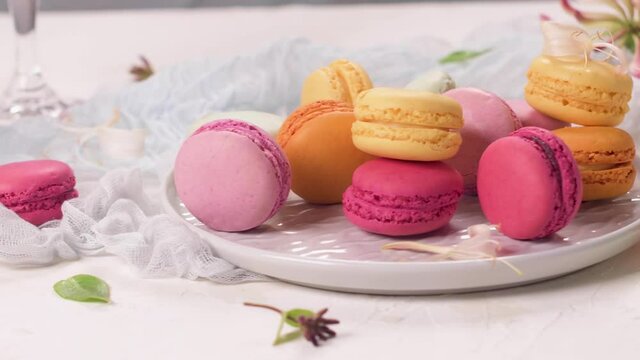 A french sweet delicacy, macaroons variety closeup. Color fresh macaroons on wooden background.