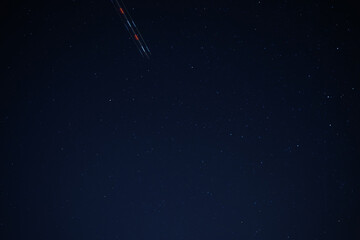 Stars and plane light trials in the night sky 