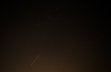 Stars and plane light trials in the night sky 