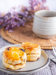 Traditional British scones with a tea cup and blurred background