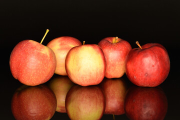 Red ripe apples, close-up, on a black background.