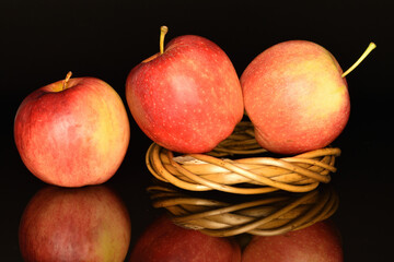 Red ripe apples, close-up, on a black background.