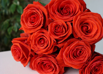 Red roses bouquet lying on a table