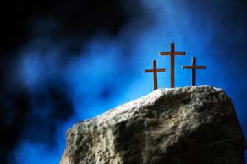 Silhouette of three crosses on Calvary hill, blue background. Crucifixion, resurrection of Jesus...