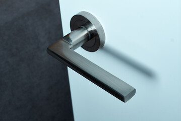 Open white door with metal doorknob object.