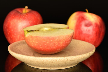Red ripe apples, close-up, on a black background.