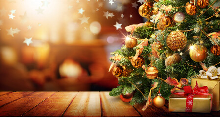 Beautiful elegant Christmas tree with Golden balls and gifts on  defocused warm evening background...