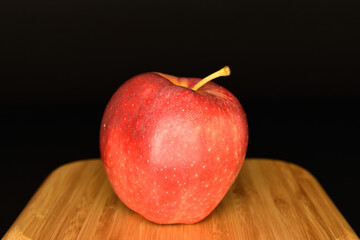 Red ripe apples, close-up, on a black background.