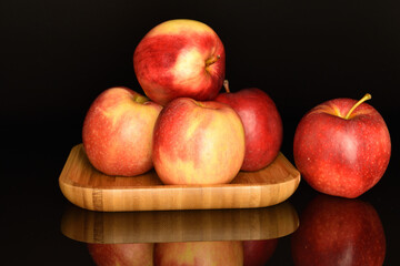 Red ripe apples, close-up, on a black background.