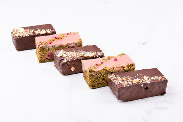 Assorted cakes with raspberries and match tea and chocolate carrots
