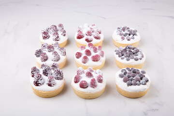 Assorted fruit-berry baskets with raspberries, blackberries and blueberries with powdered sugar
