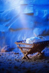 Wooden manger and star of Bethlehem in cave, nativity scene background. Christian Christmas...