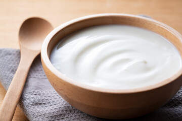 Yogurt on a wooden background