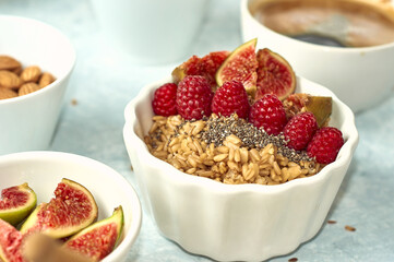 oatmeal with raspberries, figs, chia seeds and nuts for breakfast